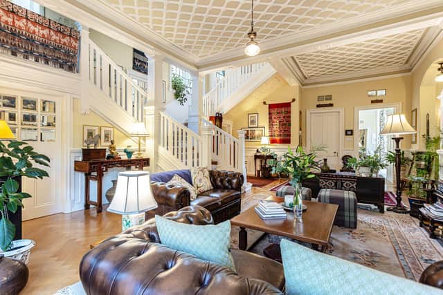 The large reception hall with split staircase is currently being used as a sitting room. Image: contributed