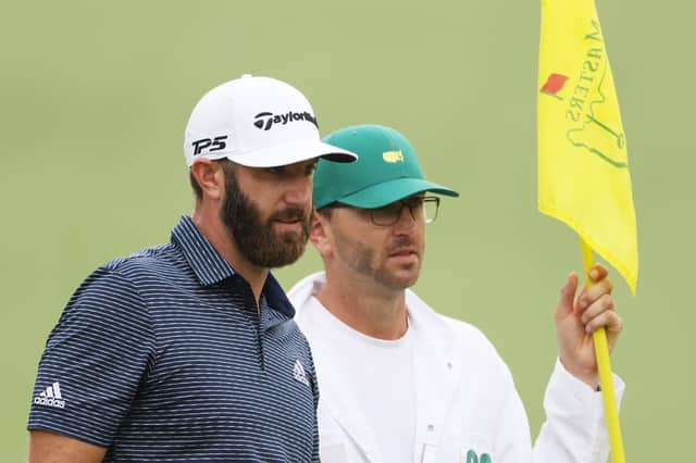 Dustin Johnson stands with his brother/caddie Austin on the tenth green during the final round of the Masters at Augusta National. Picture: Jamie Squire/Getty Images