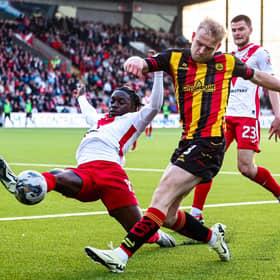 Airdrie's Kanayo Megwa and Partick Thistle's Harry Milne in action during the cinch Premiership play-off quarter final first leg.