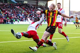 Airdrie's Kanayo Megwa and Partick Thistle's Harry Milne in action during the cinch Premiership play-off quarter final first leg.