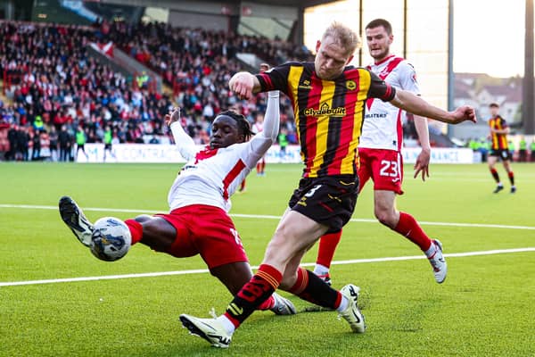 Airdrie's Kanayo Megwa and Partick Thistle's Harry Milne in action during the cinch Premiership play-off quarter final first leg.