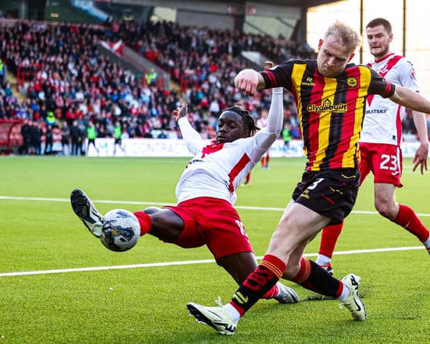 Airdrie's Kanayo Megwa and Partick Thistle's Harry Milne in action during the cinch Premiership play-off quarter final first leg.