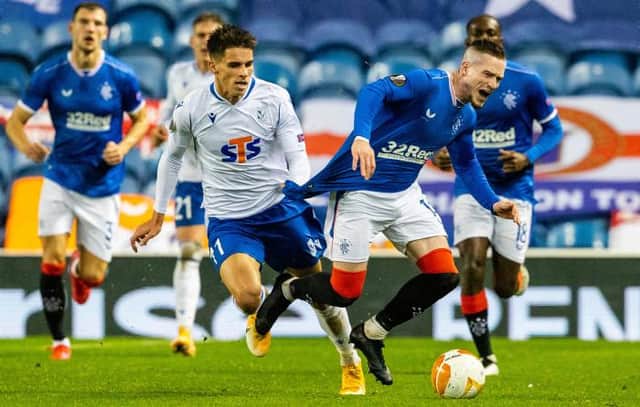 Rangers winger Ryan Kent is dragged back off the ball by Filip Marchwinski of Lech Poznan in the Europa League Group D match at Ibrox. (Photo by Alan Harvey / SNS Group)