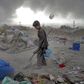 Two Afghan children collect recyclable material from a garbage dump in Kabul, Afghanistan. Picture: AP Photo/Ebrahim Noroozi