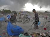 Two Afghan children collect recyclable material from a garbage dump in Kabul, Afghanistan. Picture: AP Photo/Ebrahim Noroozi
