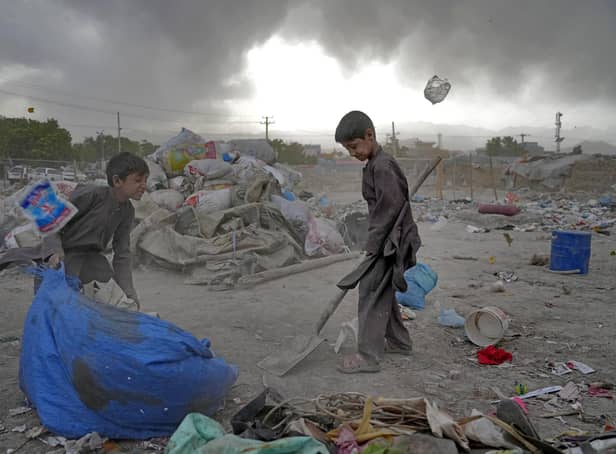 Two Afghan children collect recyclable material from a garbage dump in Kabul, Afghanistan. Picture: AP Photo/Ebrahim Noroozi