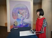 Ultra-realistic AI robot artist Ai-Da, who can draw, paint and is a performance artist, is pictured alongside her self-portrait in 2021