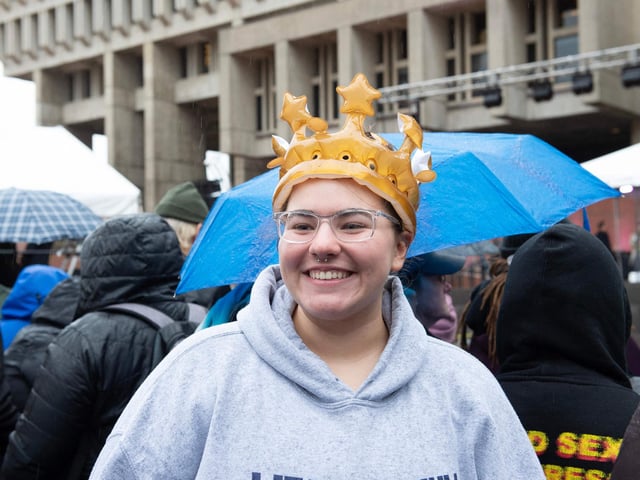 A royal fan wears an inflatable crown.