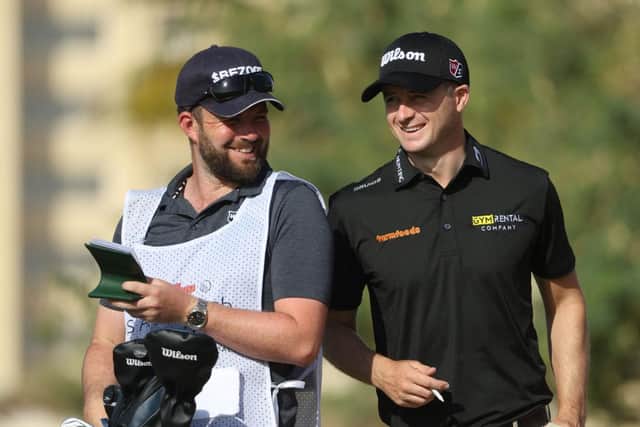 David Law and his caddie Max Bill find something funny during the second round of the Ras al Khaimah Championship presented by Phoenix Capital at Al Hamra Golf Club. Picture: Andrew Redington/Getty Images.
