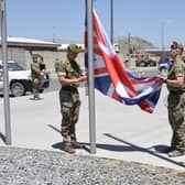 Soldiers from the Black Watch lower the Union flag in Afghanistan (Picture: Ministry of Defence)