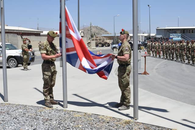 Soldiers from the Black Watch lower the Union flag in Afghanistan (Picture: Ministry of Defence)