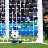 PSV goalkeeper Walter Benitez lets the ball slip over the line from Tom Lawrence's free kick to make it 2-1 to Rangers.