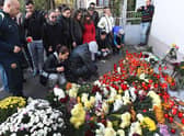 People light candles at a memorial outside the nightclub Colectiv in Bucharest in 2015, after a fire broke out, ultimately killing 64 people.