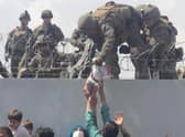 A US Marine lifts a baby over a barbed wire fence at Kabul's international airport as people scrambled to escape the advance of the Taliban in August last year (Picture courtesy of Omar Haidiri/AFP via Getty Images)