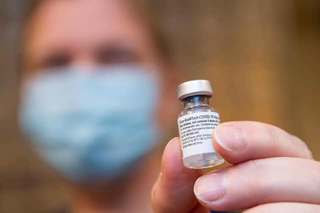 A nurse holds a vial containing the Pfizer/BioNTech Covid vaccine (Picture: Jonathan Nackstrand/AFP via Getty Images)