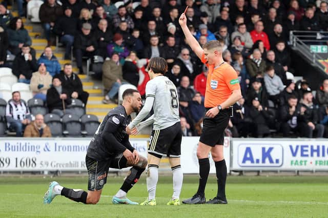 St Mirren defender Charles Dunne is sent off by referee David Dickinson for fouling Celtic