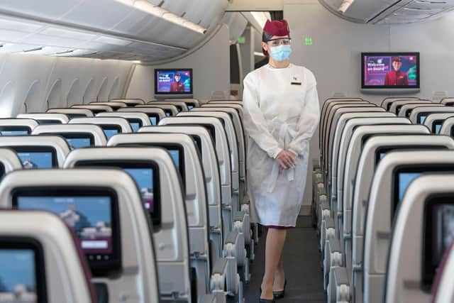 Qatar  Airways cabin crew now use protective gowns after wearing full PPE suits for a time.