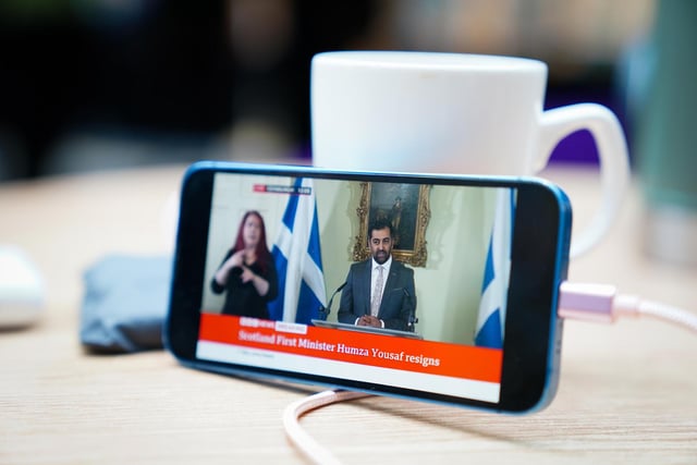 First Minister Humza Yousaf can be seen on a phone as he speaks during a press conference at Bute House, his official residence in Edinburgh, where he said he would resign as SNP leader. Picture: Jane Barlow/PA Wire