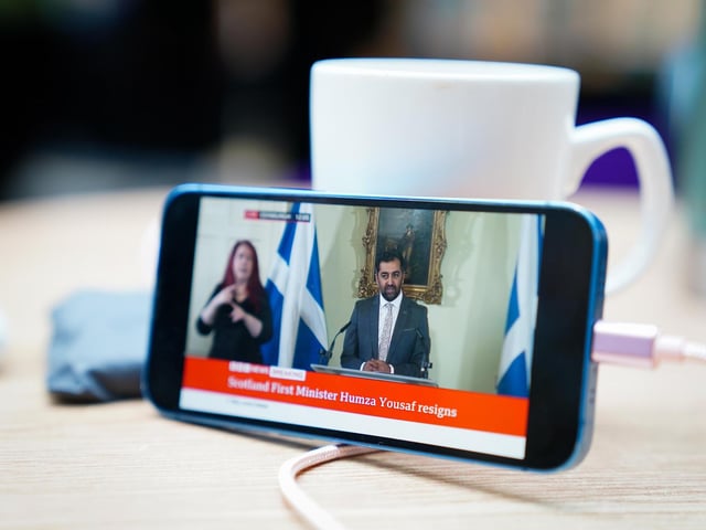 First Minister Humza Yousaf can be seen on a phone as he speaks during a press conference at Bute House, his official residence in Edinburgh, where he said he would resign as SNP leader. Picture: Jane Barlow/PA Wire