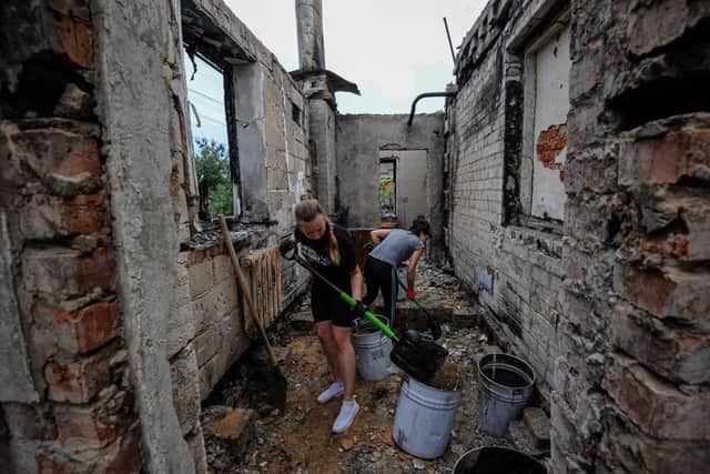 Volunteers clear the rubble of a house destroyed as a result of the shelling in the city of Chernihiv on August 20, 2022, amid Russia's invasion of Ukraine. Photo by SERGEI CHUZAVKOV/AFP via Getty Images