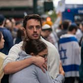 Pro-Israel supporters embrace during protests near the Israeli Consulate in New York City. Photo by Adam Gray/Getty Images