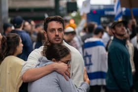Pro-Israel supporters embrace during protests near the Israeli Consulate in New York City. Photo by Adam Gray/Getty Images