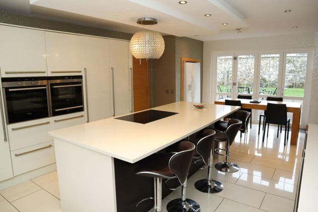 Fitted kitchen with centre island and breakfast area, and bi-folding doors to the rear patio area.
