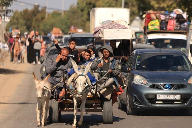 Hundreds of other Palestinians carry their belongings as they flee Gaza City following the Israeli army's warning to leave their homes and move south before an expected ground offensive. Picture: Mahmud Hams/AFP/Getty