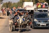 Hundreds of other Palestinians carry their belongings as they flee Gaza City following the Israeli army's warning to leave their homes and move south before an expected ground offensive. Picture: Mahmud Hams/AFP/Getty