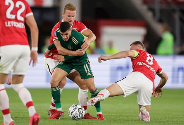 ALKMAAR, NETHERLANDS - AUGUST 26: AZ's Fredrik Midtsjo (left) tackles Celtic's Liel Abada during a Europa League Qualifier between AZ Alkmaar and Celtic at AFAS Stadium on August 26, 2021, in Alkmaar, Netherlands (Photo by Rico Brouwer / SNS Group)