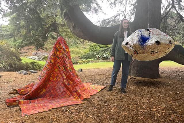 Eva Madden looks on at El Anatsui augmented reality piece AG + BA (AR), which is part of the new exhibition being hosted at the Royal Botanic Garden.