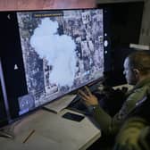 Ukrainian soldiers watch a drone feed from an underground command center in Bakhmut, in the Donetsk region, Ukraine. Picture: AP Photo/Libkos