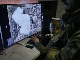 Ukrainian soldiers watch a drone feed from an underground command center in Bakhmut, in the Donetsk region, Ukraine. Picture: AP Photo/Libkos