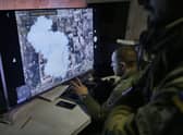 Ukrainian soldiers watch a drone feed from an underground command center in Bakhmut, in the Donetsk region, Ukraine. Picture: AP Photo/Libkos