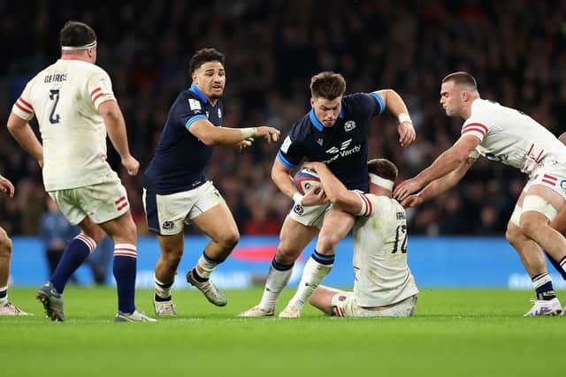 Huw Jones on the attack for Scotland at Twickenham, with Sione Tuipulotu in support. (Photo by Julian Finney/Getty Images)