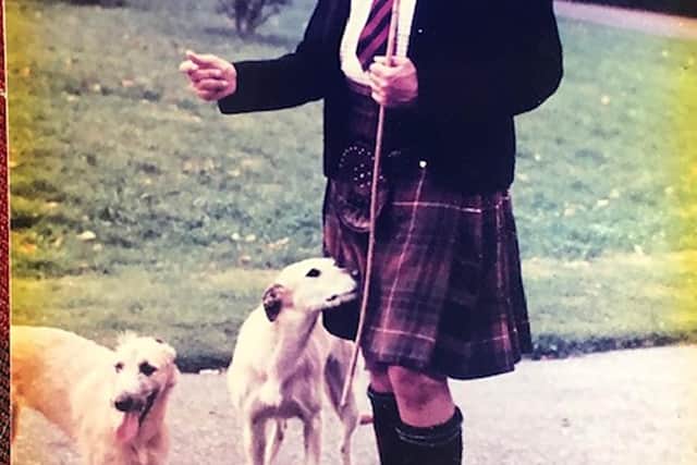 Lord Lovat,  described by his family as a "countryman at heart" at home near Beauly in later life with his two lurchers. PIC: Fraser family.