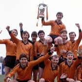 Dundee Utd captain Paul Hegarty is held aloft by Richard Gough (back row 4th right) after clinching the 1982/83 League Championship.