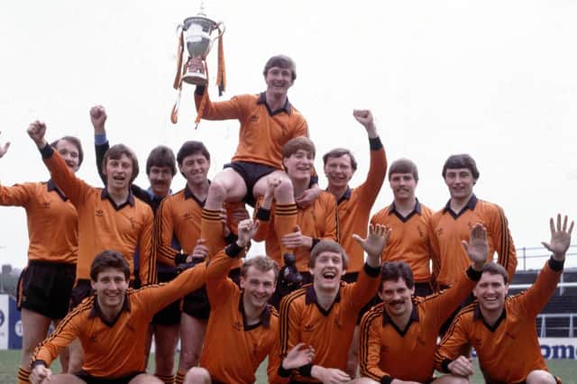 Dundee Utd captain Paul Hegarty is held aloft by Richard Gough (back row 4th right) after clinching the 1982/83 League Championship.