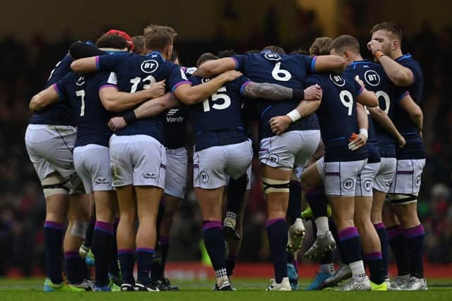 Scotland players form a group huddle on the pitch at the Principality Stadium in Cardiff (Photo by PAUL ELLIS/AFP via Getty Images)
