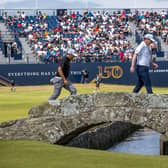 Bob MacIntyre crosss over the Swilcan Bridge with playing partner Justin De Los Santos on his way to the 18th green during the third round of the 150th Open at St Andrews. Picture: Ian Rutherford.