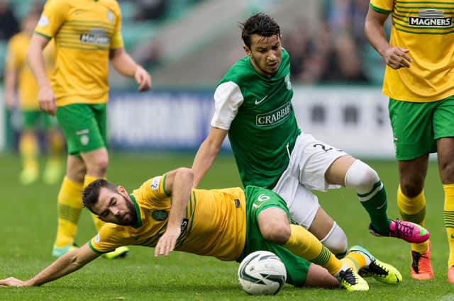 Abdellah Zoubir is tackled by Celtic's Joe Ledley during his spell at Easter Road. Picture: SNS