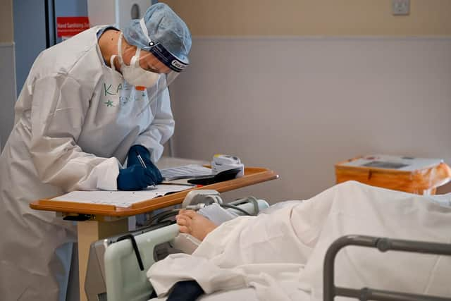 A member of staff at University Hospital Monklands attends to a Covid-positive patient on the ICU ward on February 5, 2021 in Airdrie, Scotland. Photo by Jeff J Mitchell/Getty Images