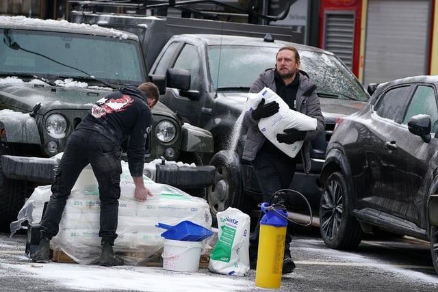 Set Dressers dress the set with fake snow on the set in Glasgow, for what is believed to be the film set of the new Batgirl movie. (Photo: Andrew Milligan/PA Wire).