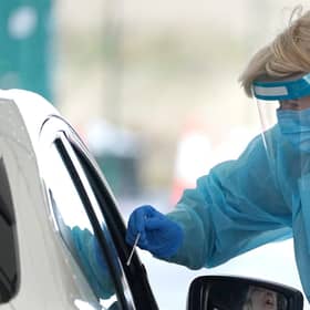 A member of staff takes a sample from a member of the public at a Covid-19 Test Site at Edinburgh Airport. Picture: PA