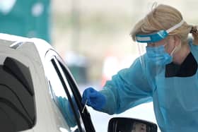 A member of staff takes a sample from a member of the public at a Covid-19 Test Site at Edinburgh Airport. Picture: PA