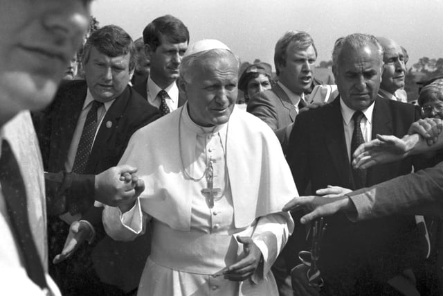 Security is tight but well-wishers manage to touch Pope John Paul II on his arrival at Turnhouse airport.