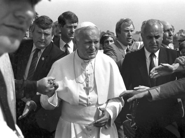 Security is tight but well-wishers manage to touch Pope John Paul II on his arrival at Turnhouse airport.
