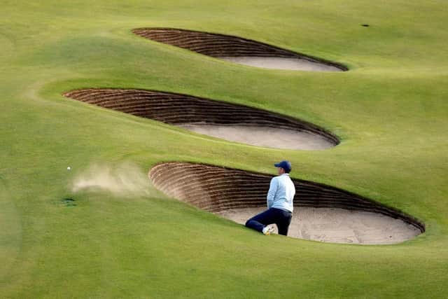 Rory McIlroy needed two attempts to escape from a greenside bunker at the 18th in his opening round in the 151st Open at Royal Liverpool. Picture: Warren Little/Getty Images.