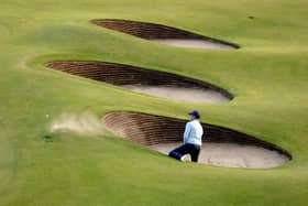 Rory McIlroy needed two attempts to escape from a greenside bunker at the 18th in his opening round in the 151st Open at Royal Liverpool. Picture: Warren Little/Getty Images.