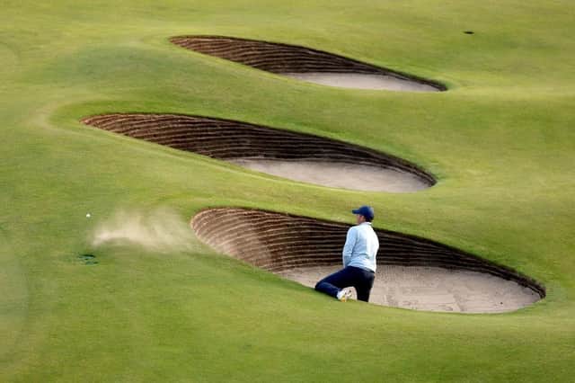 Rory McIlroy needed two attempts to escape from a greenside bunker at the 18th in his opening round in the 151st Open at Royal Liverpool. Picture: Warren Little/Getty Images.